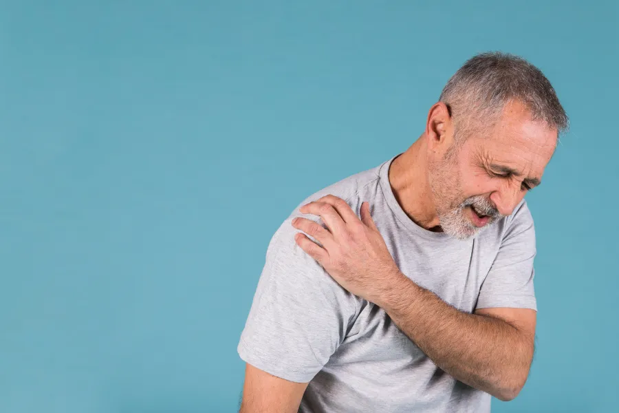 senior man having shoulder pain image
